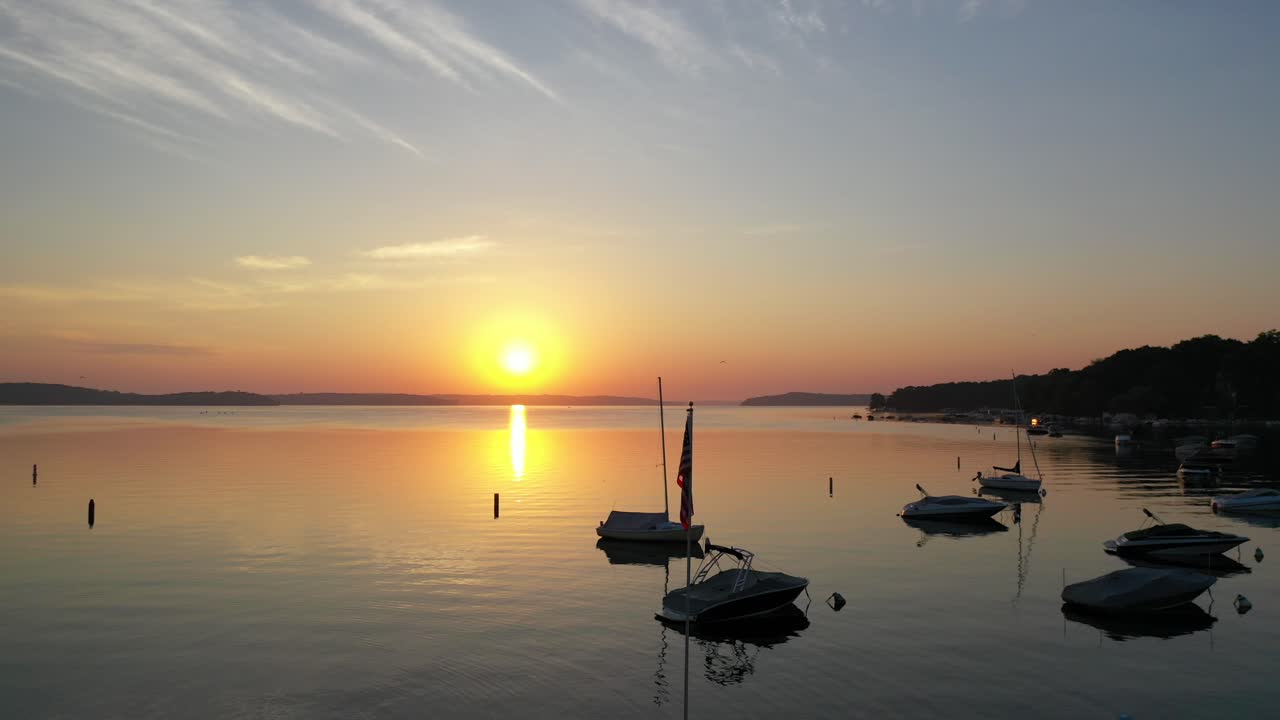 Beautiful marina during golden hour with a light house monument.