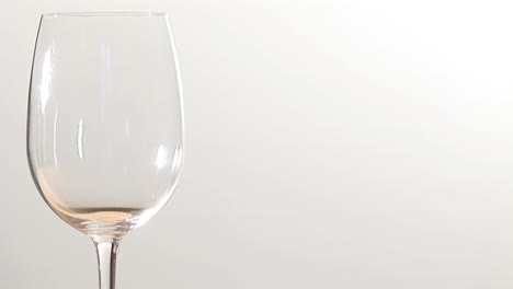 animation of burning paper over glass of wine on white background