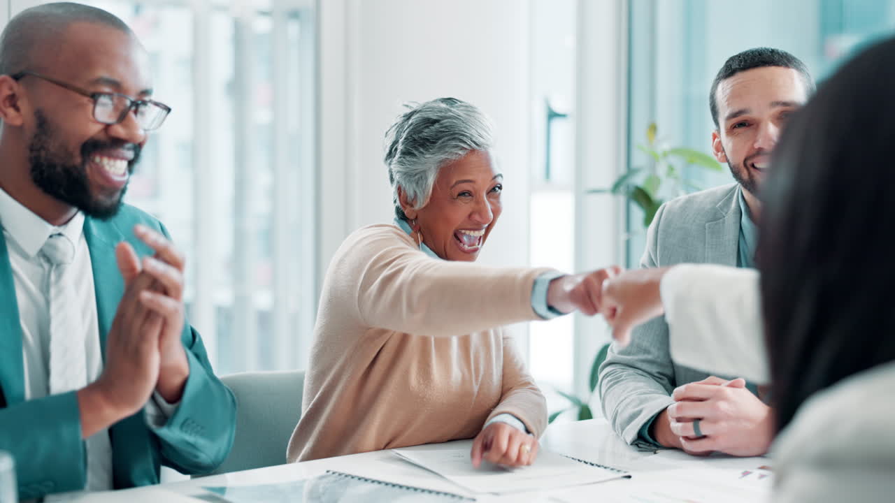 Diverse team celebrating success in a business meeting