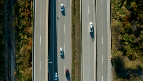 top down aerial view of cars driving along a busy highway