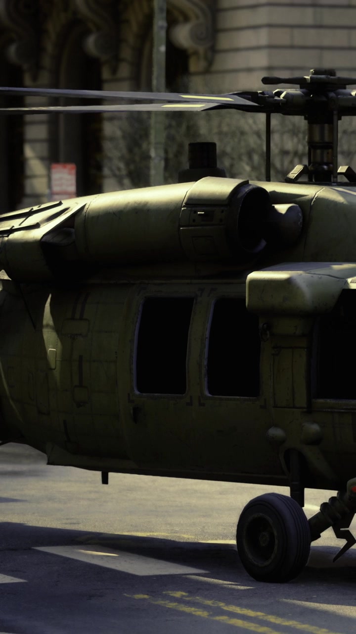 Military helicopter on street during daytime in urban area