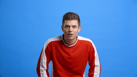 studio shot of sports fan celebrating result in slow motion