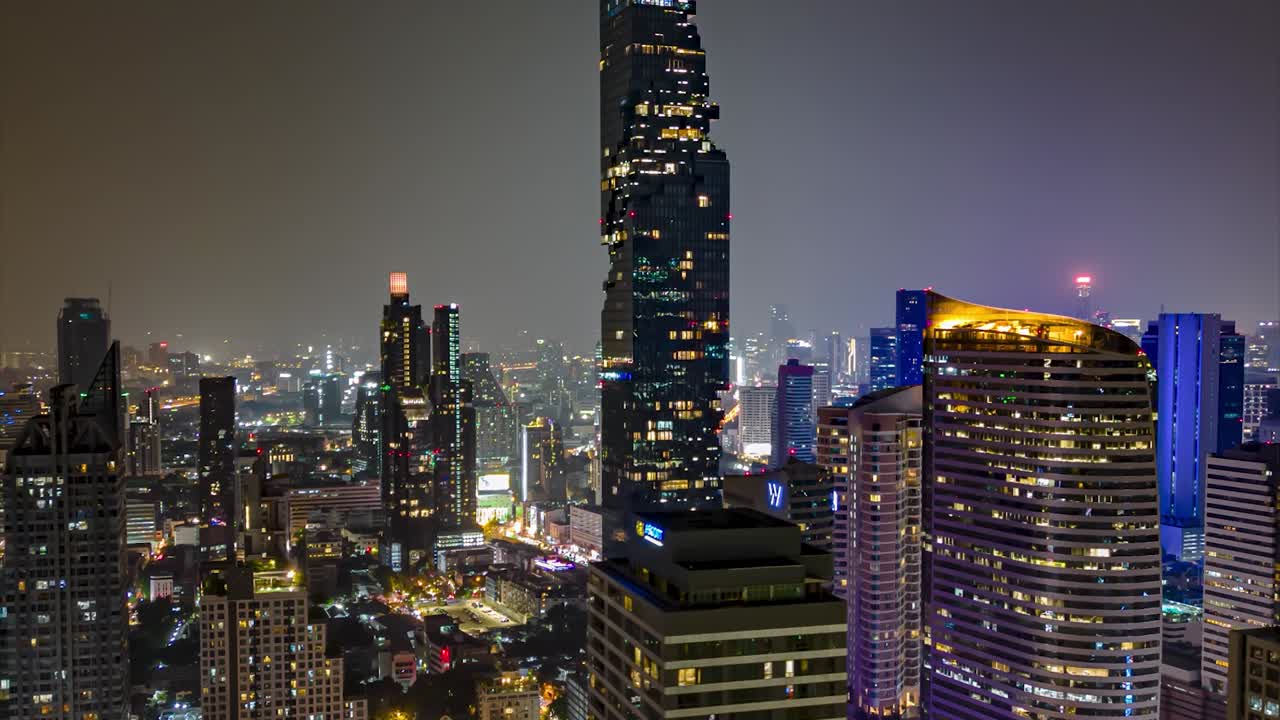 centro de la ciudad de bangkok por la noche con calles bulliciosas y concurridas, vista de los impresionantes edificios más altos iluminados por luces brillantes, hiperlapso cinematográfico