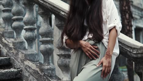 woman with henna tattoo on stairs