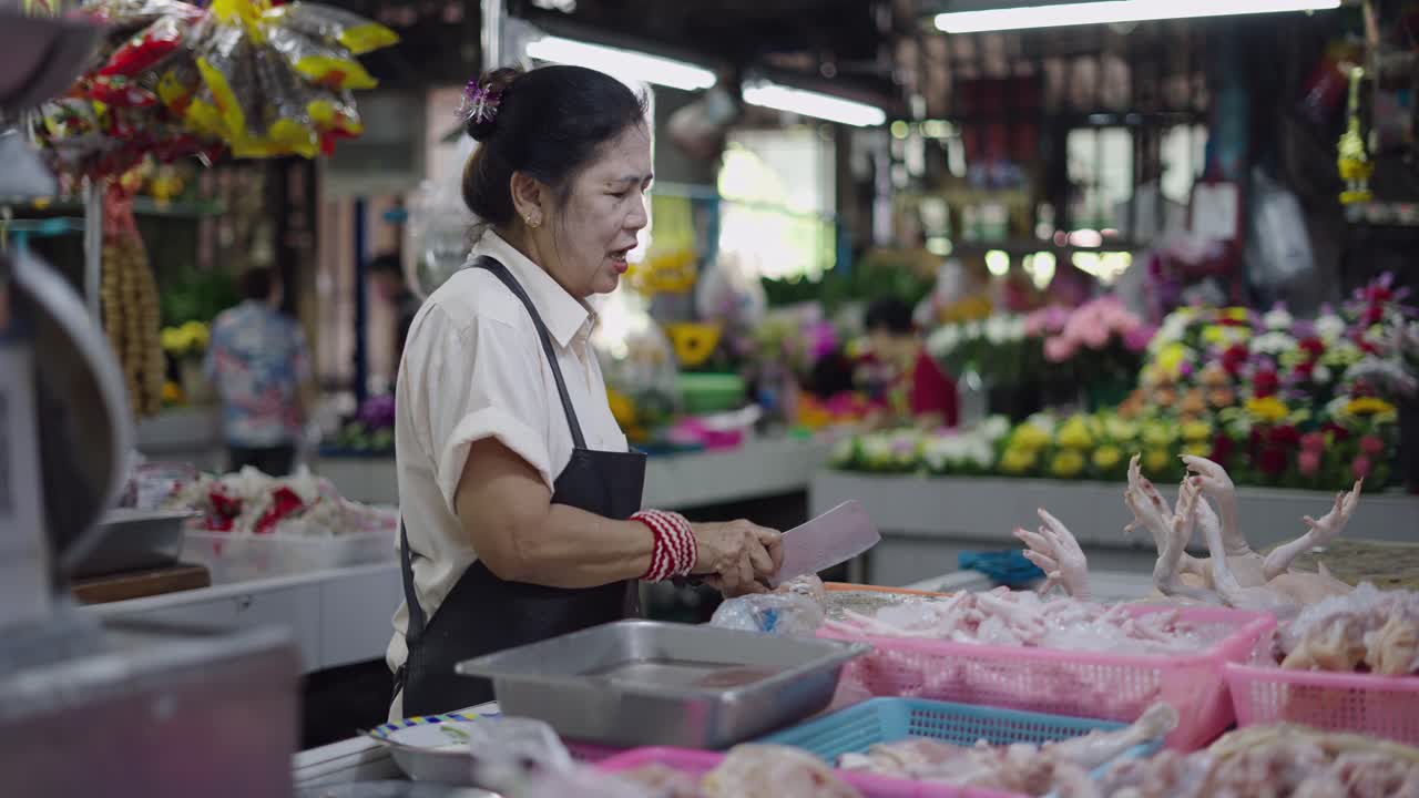 Woman Butchering Chicken at a Market