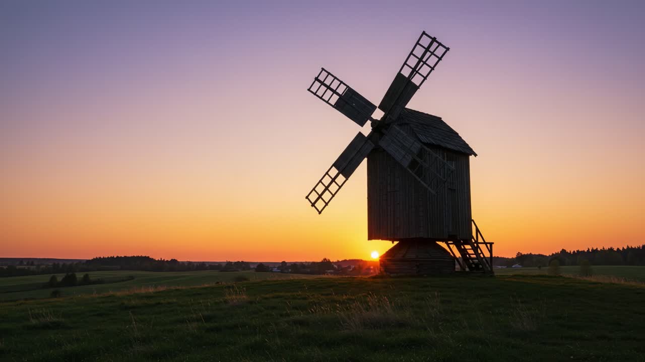 A Tranquil Sunset Over a Traditional Windmill Nestled in Rolling Fields, Capturing the Essence of Nature's Beauty and Serene Landscapes