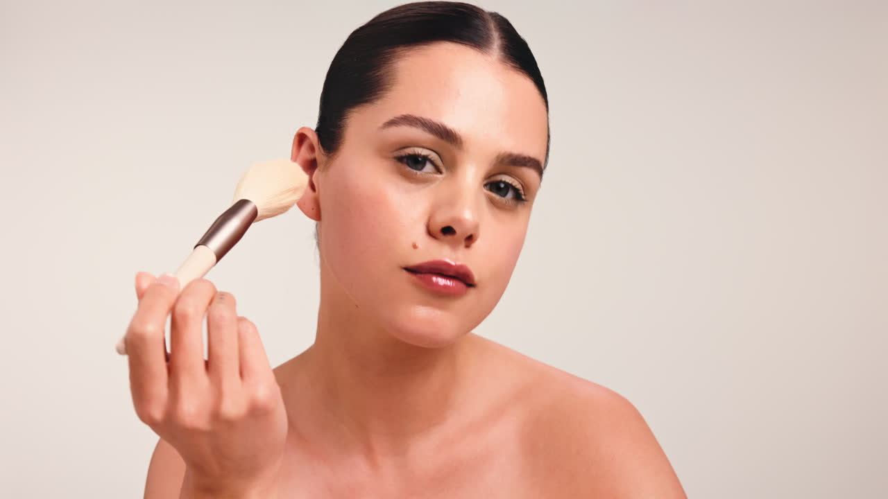 Mujer aplicando maquillaje con un pincel