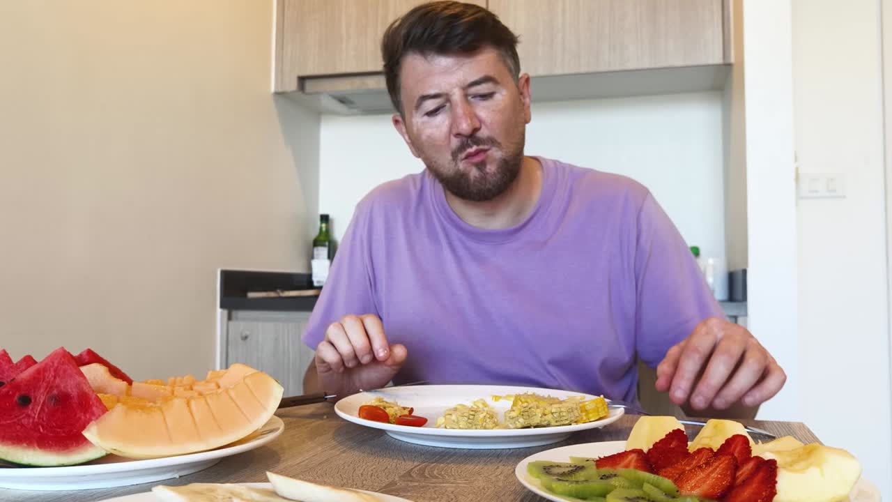 Man eating fruit at a table