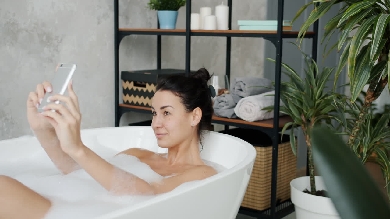 Woman Taking a Selfie in a Bathtub
