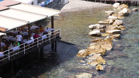 people dining by the sea in naples