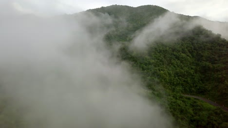 Logistic-concept-aerial-view-of-countryside-road---motorway-passing-through-the-serene-lush-greenery-and-foliage-tropical-rain-forest-mountain-landscape