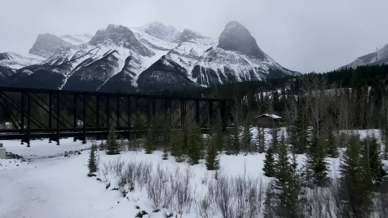 Pan up from creek toward mountains