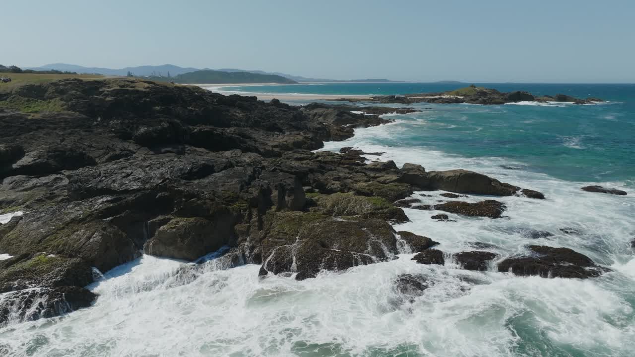 Drone clip of waves crashing onto rocky shoreline in Australia