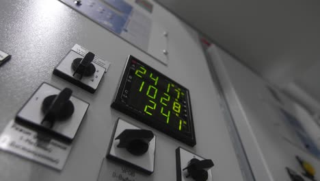 cabinet with switchboard and green glowing digits on screen