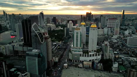 aerial drone cityscape of bangkok thailand with sunset skyline skyscrapers thai capital, establishing shot at bang rak business district