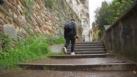 young man walking up the stairs of a medieval castle