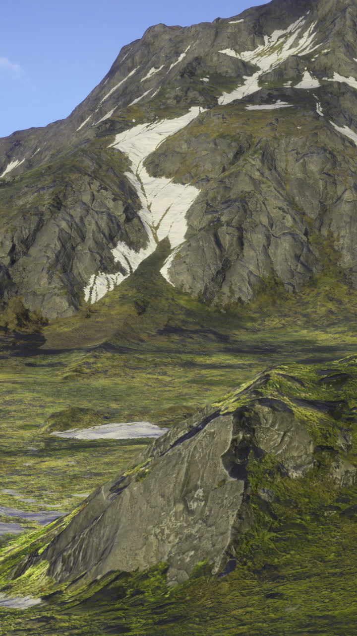 Mountainous landscape with lush valleys and remnants of snow in spring