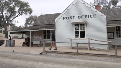 a man walks past a historic post office