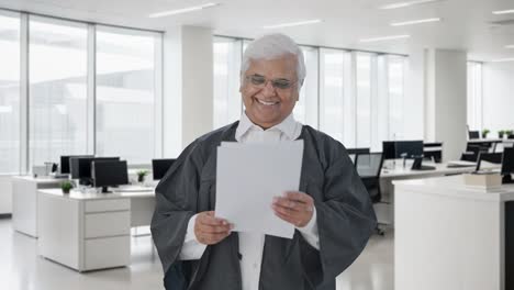 Happy-Indian-senior-lawyer-reading-court-case-papers