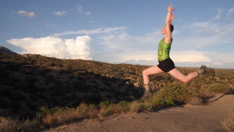 gymnast jumps into the air posing with her arms over her head