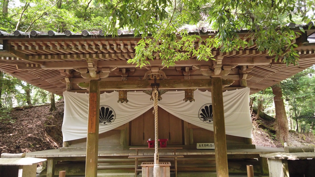 Details of Japanese wooden temple with Sacred Bell in Kuramadera, Kyoto Mountain around forest landscape