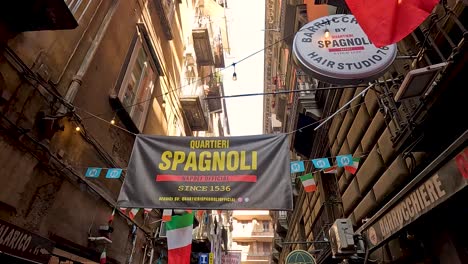 people walking in naples' quartieri spagnoli alley