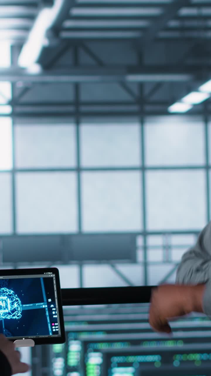 Vertical video Team of engineers in data center with tablet integrating AI automation tools