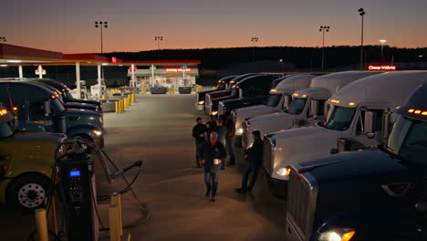 truckers at a busy truck stop during dusk