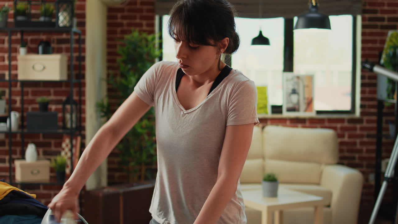 Frustrated woman ironing clothes and being angry at husband