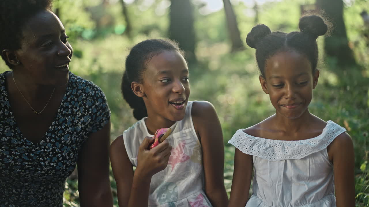 Family enjoying donuts outdoors