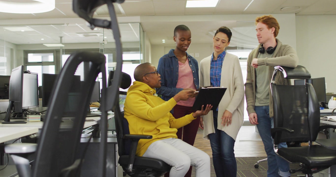 Seated presenter tapping tablet while team pointing, spawning animated notifications for marketing