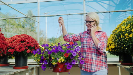 woman carrying hanging basket with flowers