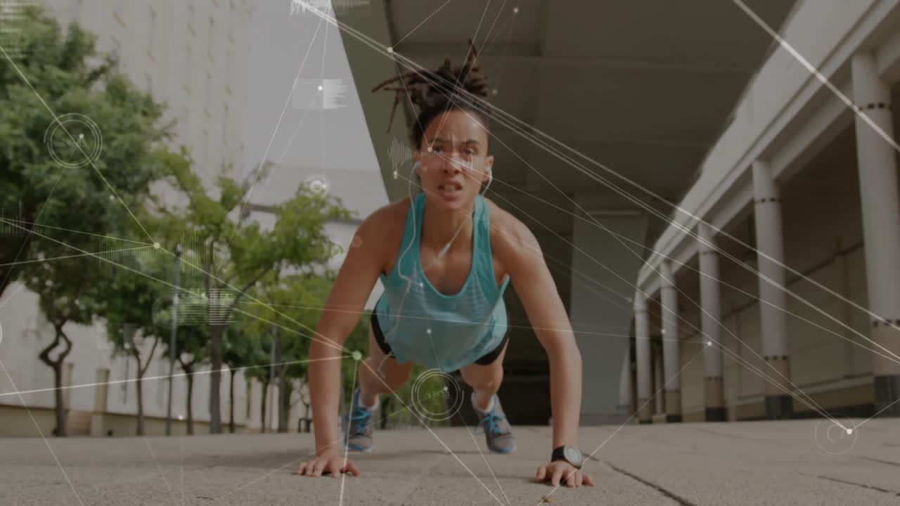 Doing push-ups, woman exercising outdoors with data processing animation over her