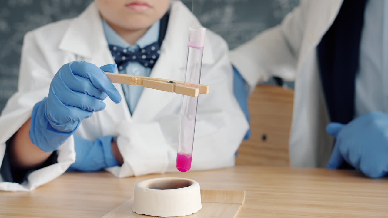Child conducting a science experiment with a teacher