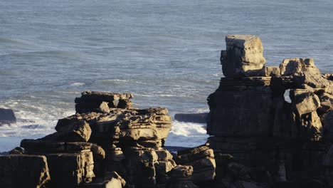 Rocky-coast-in-Portugal-Peniche,-ocean-in-background,-stable-view
