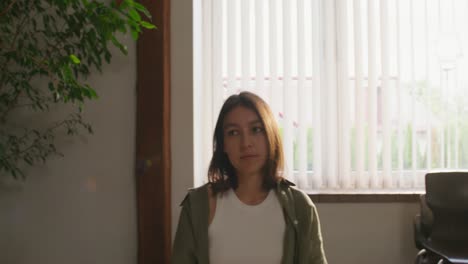 group of young adults having a conversation in a room