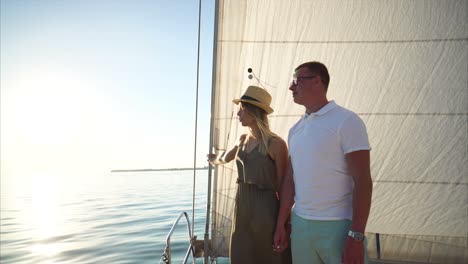 couple sailing on a yacht at sunset