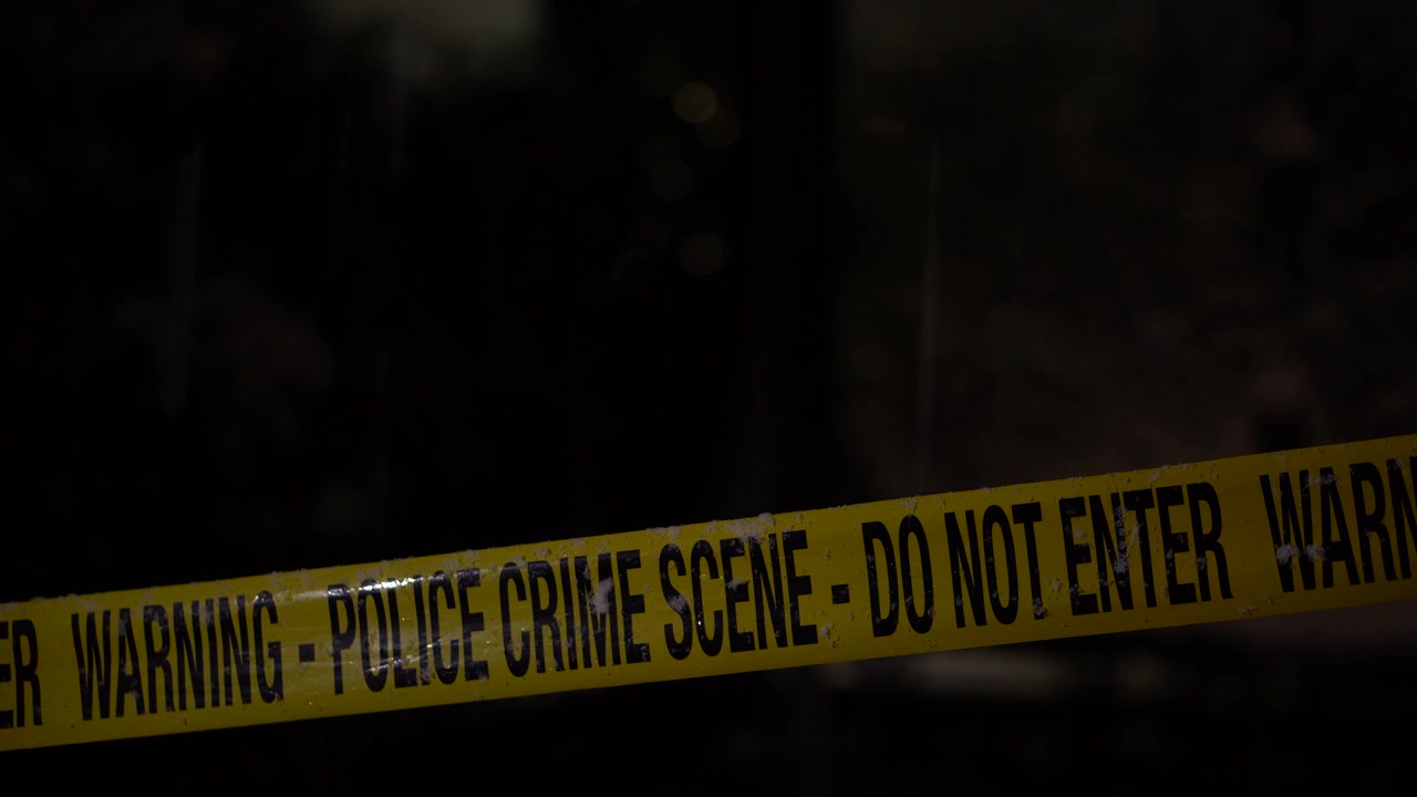 Police Crime Scene Tape in Snowy Winter Night, Close Up