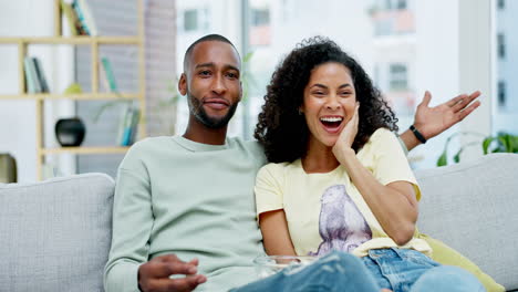 Laughing,-popcorn-and-couple-watching-tv-in-home