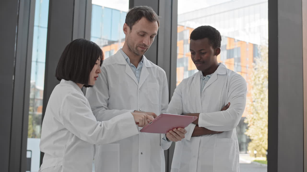 Three Scientists Using Tablet