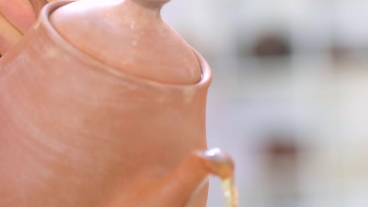 The Art of Craftsmanship: A Close-Up View of a Handcrafted Clay Teapot and Colorful Mug, Showcasing Unique Textures and Vibrant Designs in Pottery