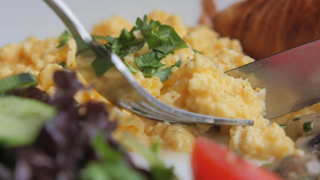Scrambled Eggs Breakfast with Salad and Croissant