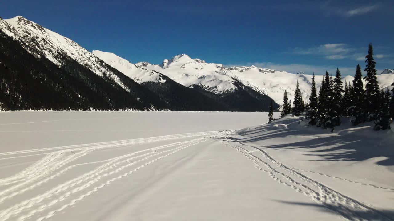 Incredible approach Shot of the snow covered frozen Garibaldi Lake in Winter