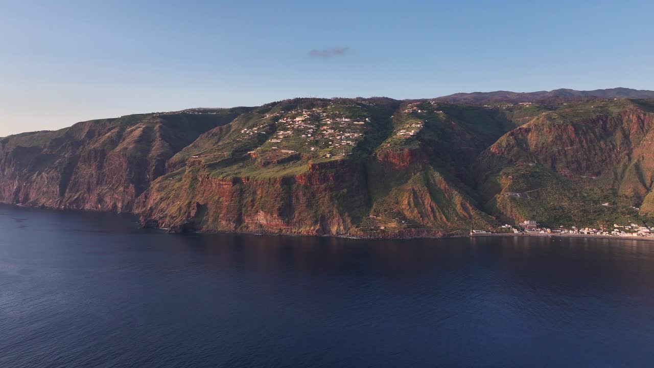 Sunset aerial view over ocean of Faja da Ovelha civil parish in Calheta, Madeira