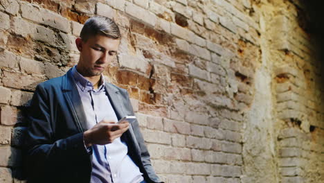 the sad young man in a suit uses a phone it should be in an abandoned house concept - problems bankr