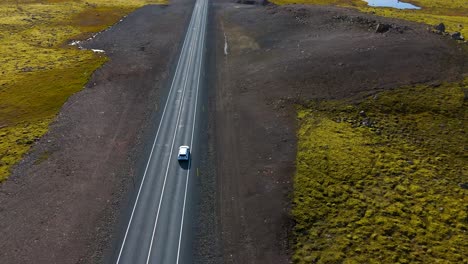 aerial tracking shot of a car traveling across iceland visiting tourist spots