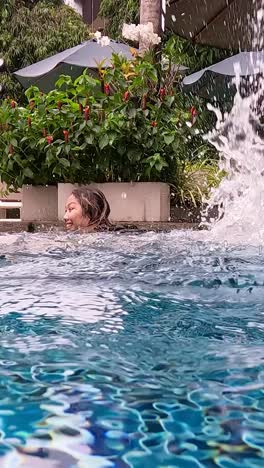 persona nadando y salpicando en una piscina