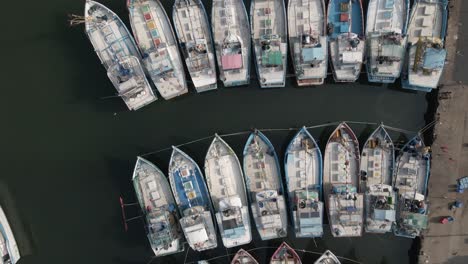 flyover looks straight down onto fishing boat pattern in tight marina