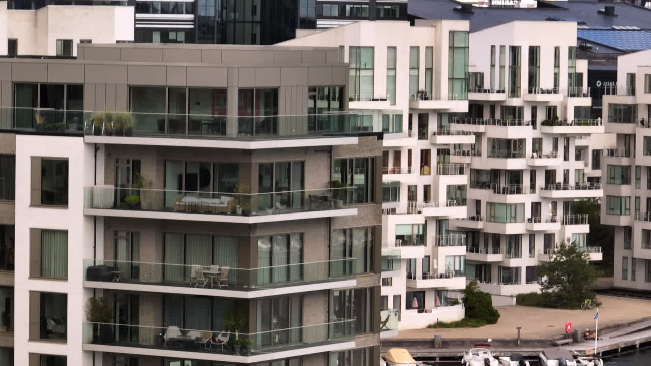 Telephoto drone shot circling riverside, luxury condos in Copenhagen, Denmark