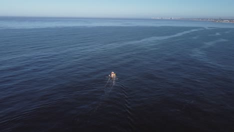 aerial tracking shot of fishing boat on the uruguayan coast in the atlantic ocean